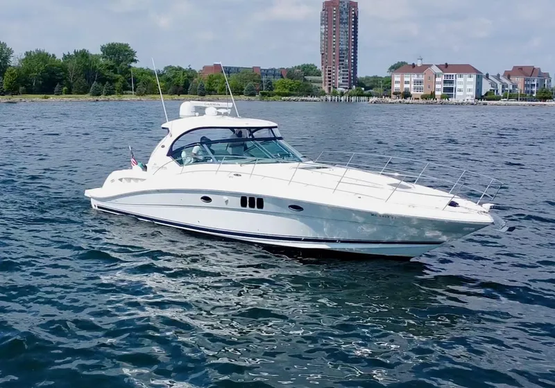 Slide: The Image of 2006 Sea Ray 44 Sundancer yacht cruising near waterfront buildings. - 10