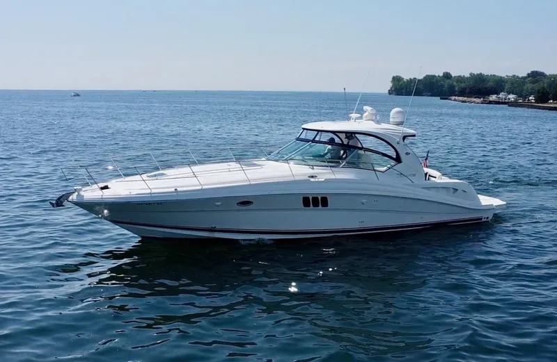 Slide: The Image of 2006 Sea Ray 44 Sundancer yacht cruising on calm blue waters. - 14