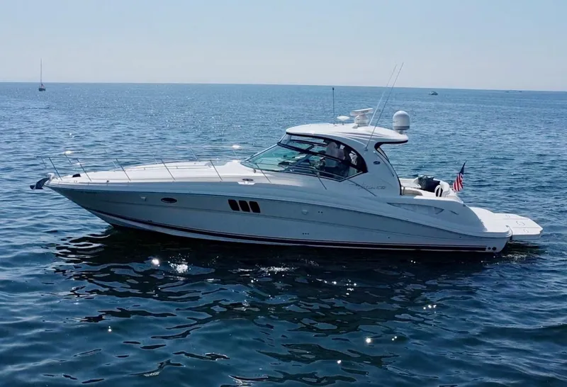 Slide: The Image of 2006 Sea Ray 44 Sundancer yacht cruising on open water. - 15