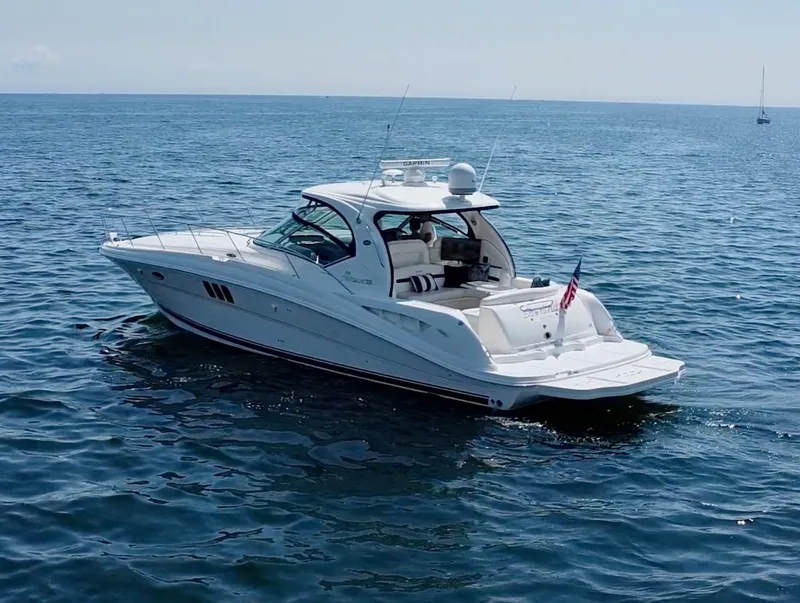 Slide: The Image of 2006 Sea Ray 44 Sundancer yacht cruising on open water. - 16