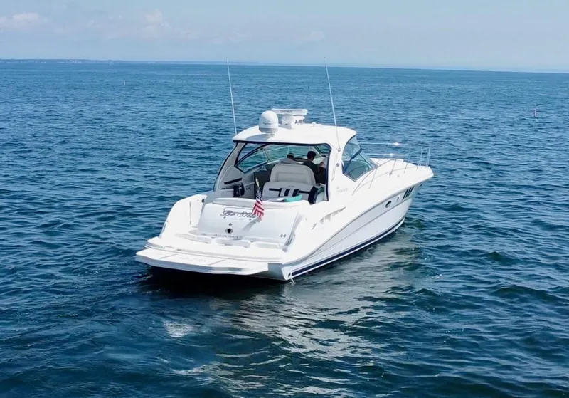 Slide: The Image of 2006 Sea Ray 44 Sundancer yacht cruising on open water. - 18