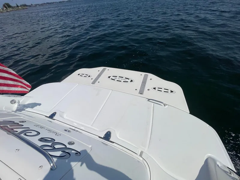 Slide: The Image of 2006 Sea Ray 44 Sundancer boat on water, rear view with American flag. - 21