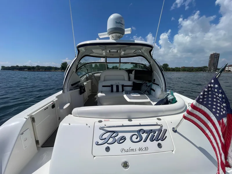 Slide: The Image of 2006 Sea Ray 44 Sundancer yacht on water, American flag, clear sky. - 22