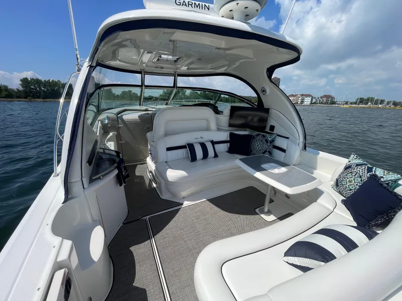 Slide: The Image of 2006 Sea Ray 44 Sundancer yacht interior with plush seating and scenic water view. - 23