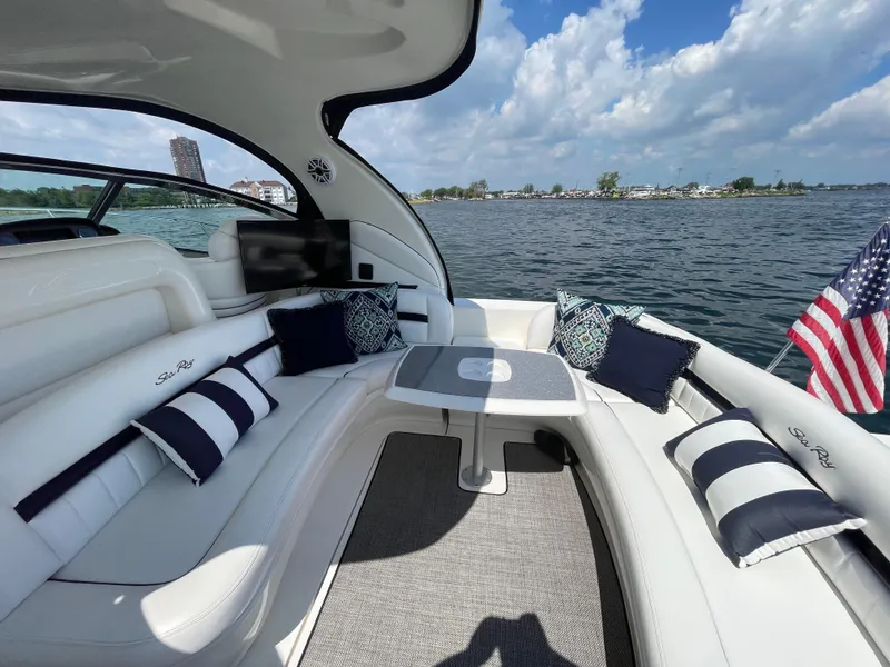 Slide: The Image of Luxurious 2006 Sea Ray 44 Sundancer yacht interior with plush seating and scenic water view. - 24