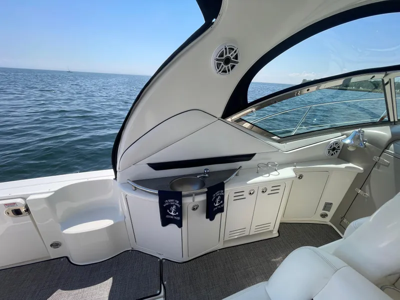 Slide: The Image of 2006 Sea Ray 44 Sundancer yacht interior with ocean view, featuring sleek design and luxury seating. - 27