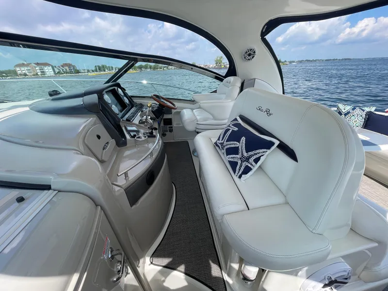 Slide: The Image of 2006 Sea Ray 44 Sundancer yacht interior with plush seating and modern dashboard. - 32