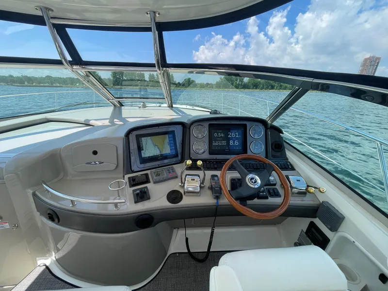 Slide: The Image of Helm of 2006 Sea Ray 44 Sundancer yacht with navigation equipment and steering wheel. - 33