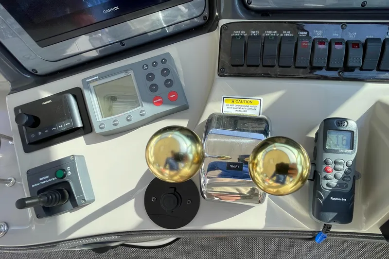 Slide: The Image of Control panel of a 2006 Sea Ray 44 Sundancer with navigation and throttle controls. - 36