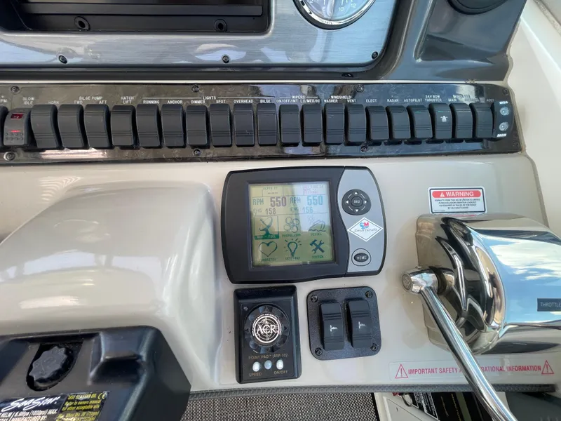 Slide: The Image of Control panel of 2006 Sea Ray 44 Sundancer boat with switches and display. - 38