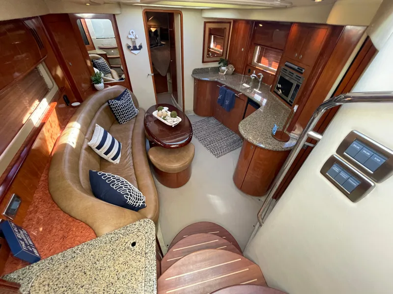 Slide: The Image of Luxurious interior of 2006 Sea Ray 44 Sundancer yacht with elegant seating and kitchen area. - 42