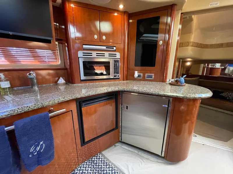 Slide: The Image of Luxurious 2006 Sea Ray 44 Sundancer yacht interior with modern kitchen amenities. - 47