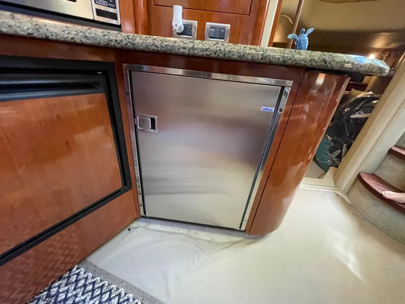 Slide: The Image of Interior of 2006 Sea Ray 44 Sundancer yacht with stainless steel fridge and granite countertop. - 48
