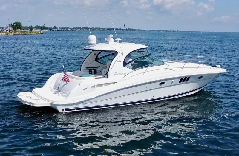Slide: The Image of 2006 Sea Ray 44 Sundancer yacht cruising on open water under a clear sky. - 8