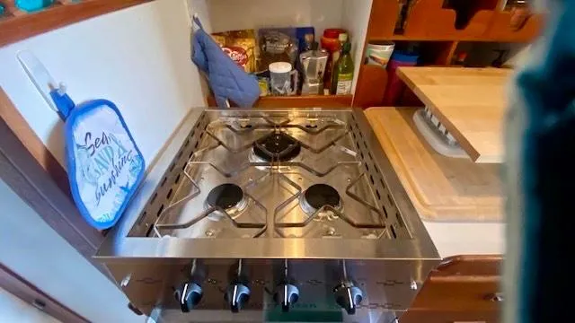 Slide: The Image of Compact kitchen stove in 1987 Roughwater 37 boat, surrounded by cooking essentials. - 13