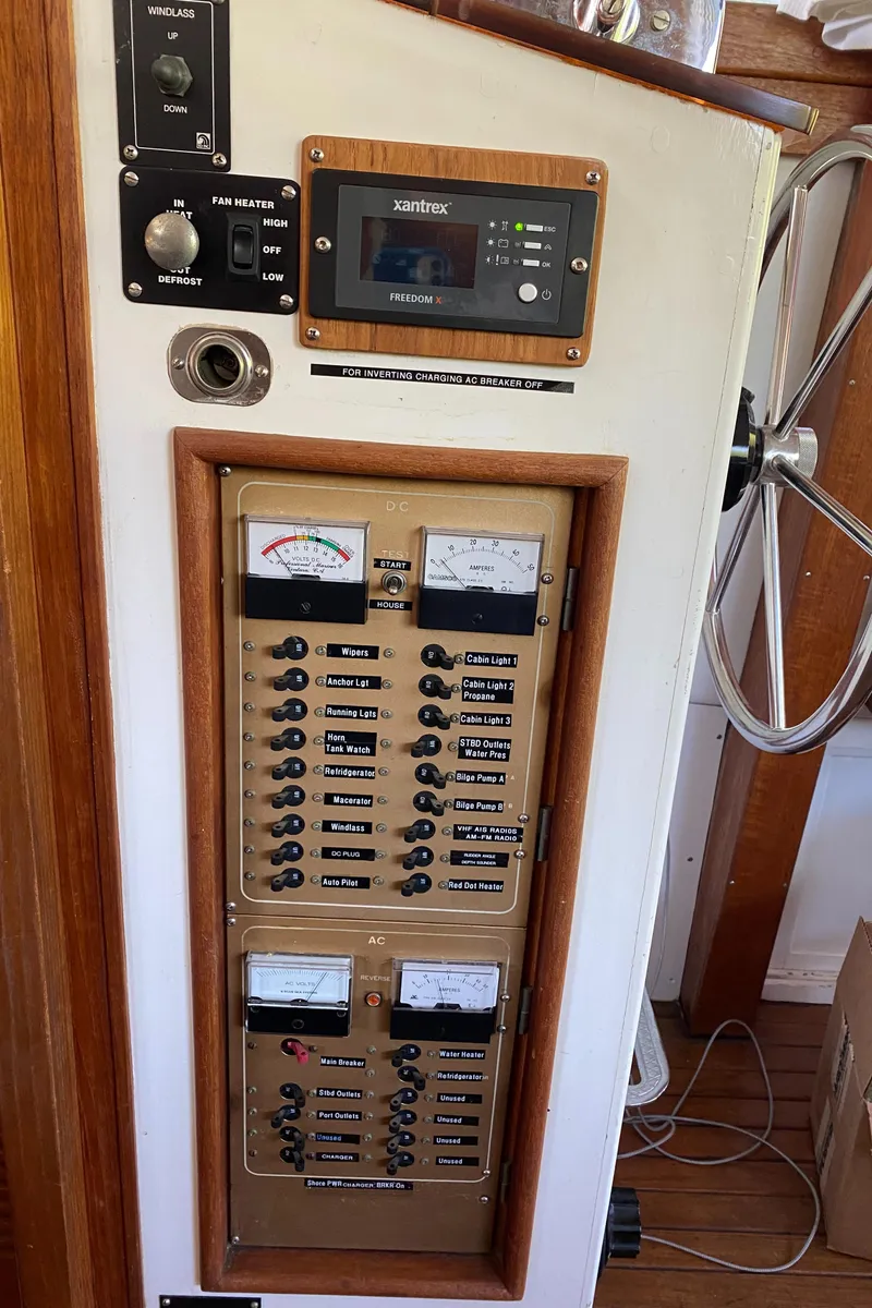 Slide: The Image of Electrical control panel on a 1987 Roughwater 37 boat, featuring switches and gauges. - 20