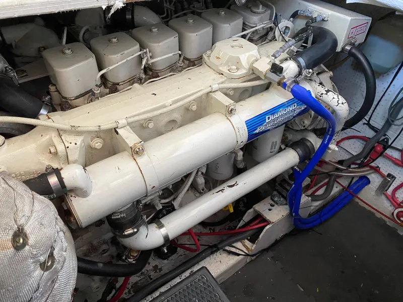 Slide: The Image of Engine compartment of a 1987 Roughwater 37 boat, featuring a well-maintained marine engine. - 21