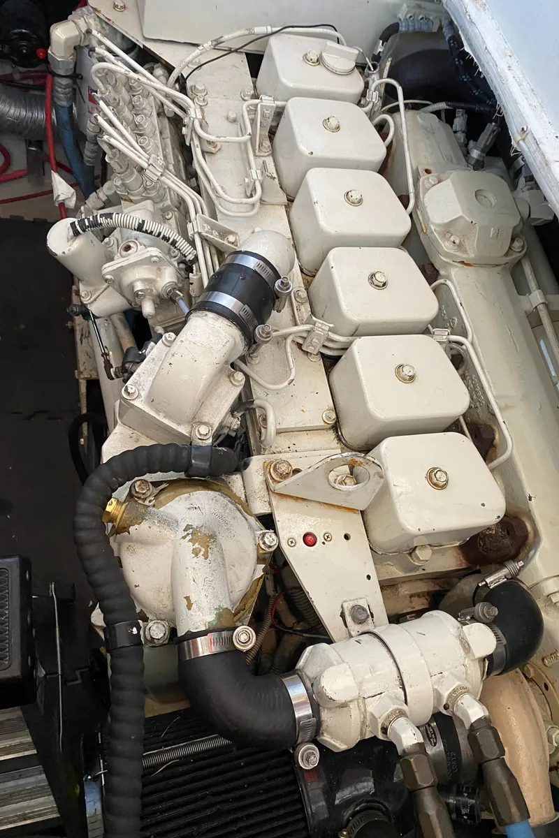 Slide: The Image of Engine of a 1987 Roughwater 37 boat, showcasing intricate mechanical components. - 22