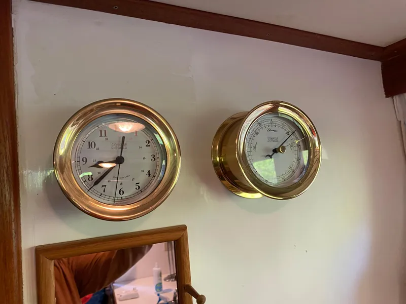 Slide: The Image of Brass clock and barometer on 1987 Roughwater 37 boat interior wall. - 25