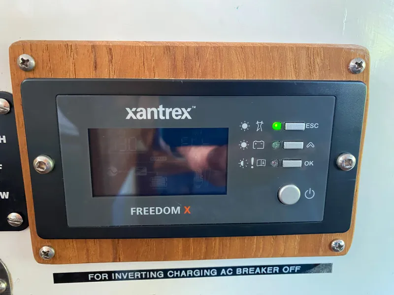 Slide: The Image of Xantrex Freedom X control panel on 1987 Roughwater 37 boat, mounted on wood. - 26