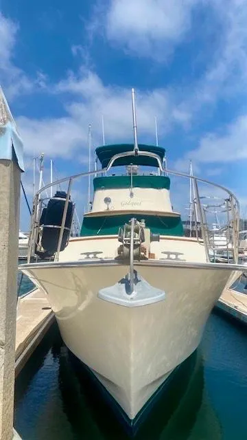 Slide: The Image of 1987 Roughwater 37 boat docked under a clear blue sky. - 3
