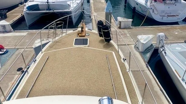Slide: The Image of 1987 Roughwater 37 boat docked at marina, view of bow and surrounding vessels. - 5