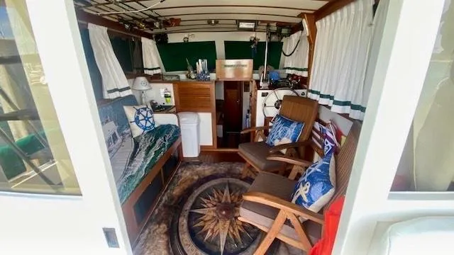 Slide: The Image of Cozy interior of 1987 Roughwater 37 boat with nautical decor and seating area. - 7