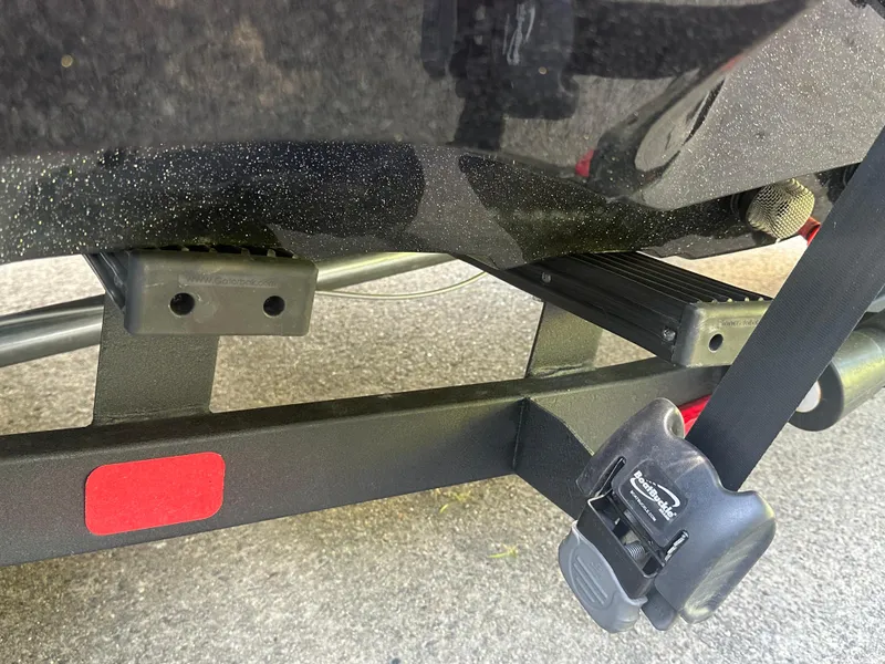 Slide: The Image of 2024 Nitro Z21XL boat trailer with secure tie-down strap and reflective marker. - 10