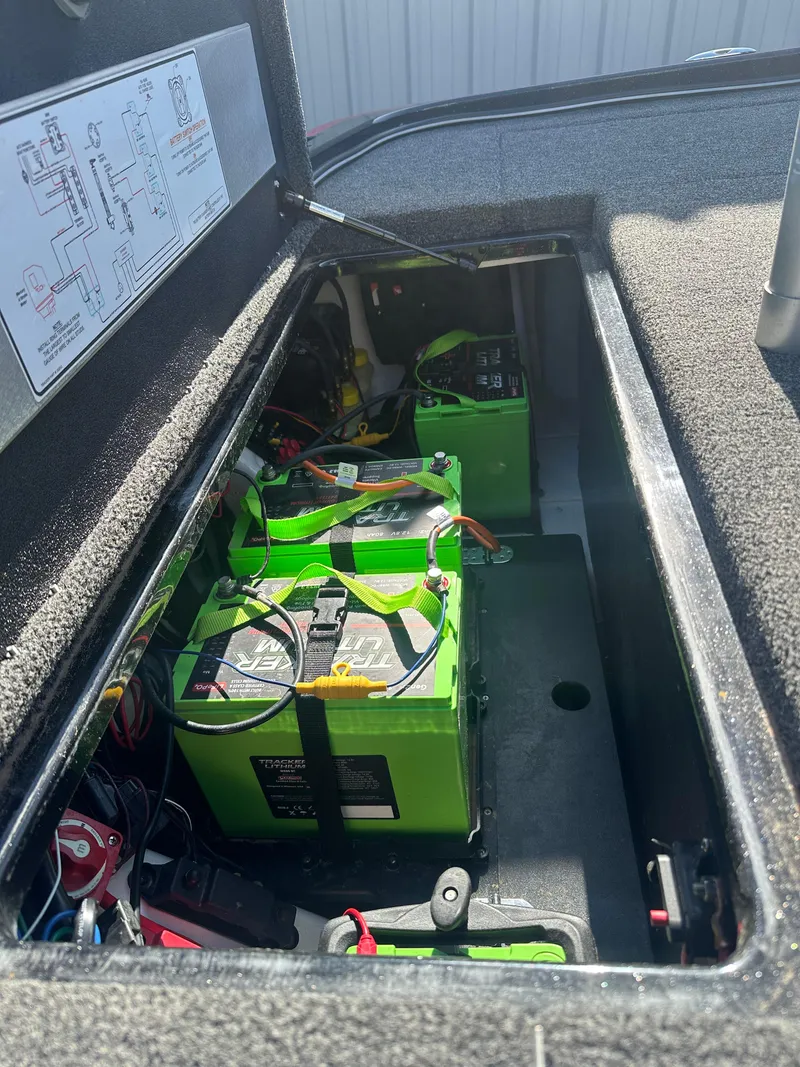 Slide: The Image of 2024 Nitro Z21XL boat battery compartment with green batteries and wiring. - 11