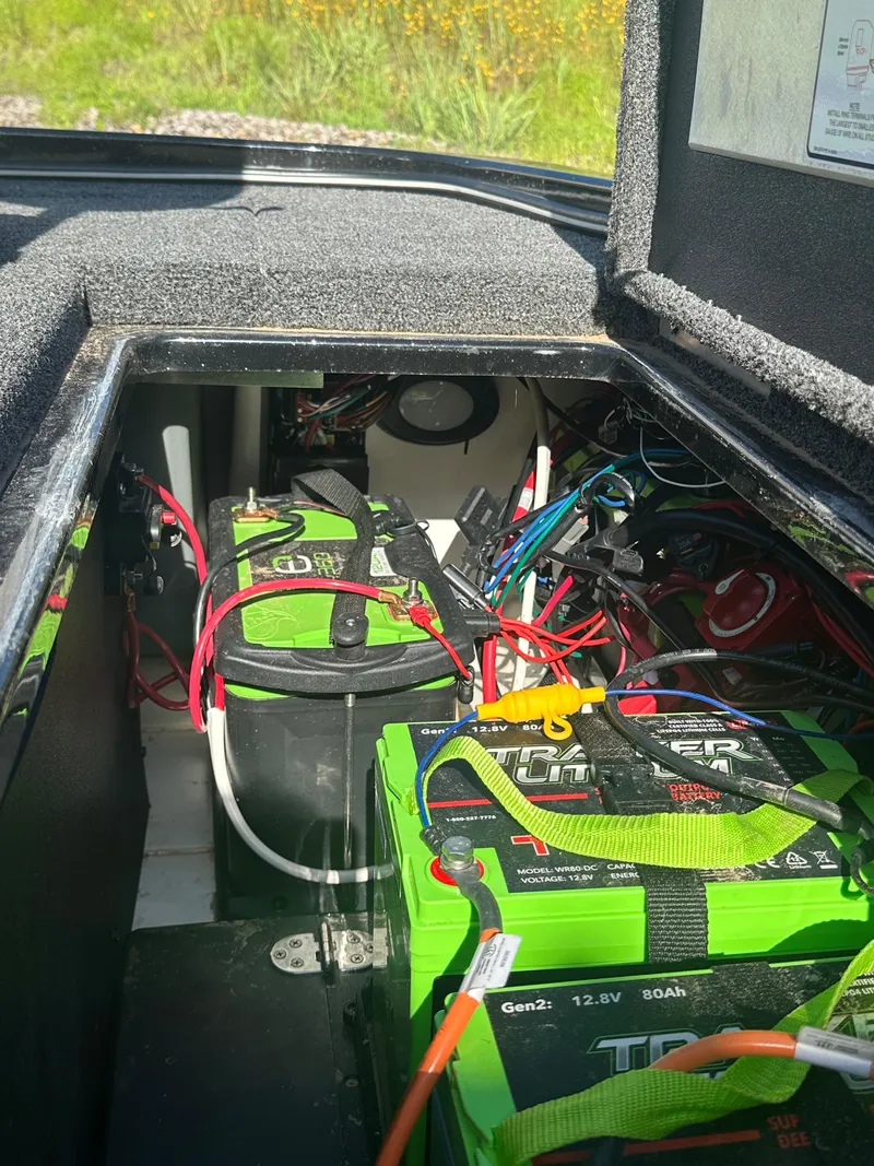 Slide: The Image of 2024 Nitro Z21XL boat battery compartment with green batteries and wiring. - 15