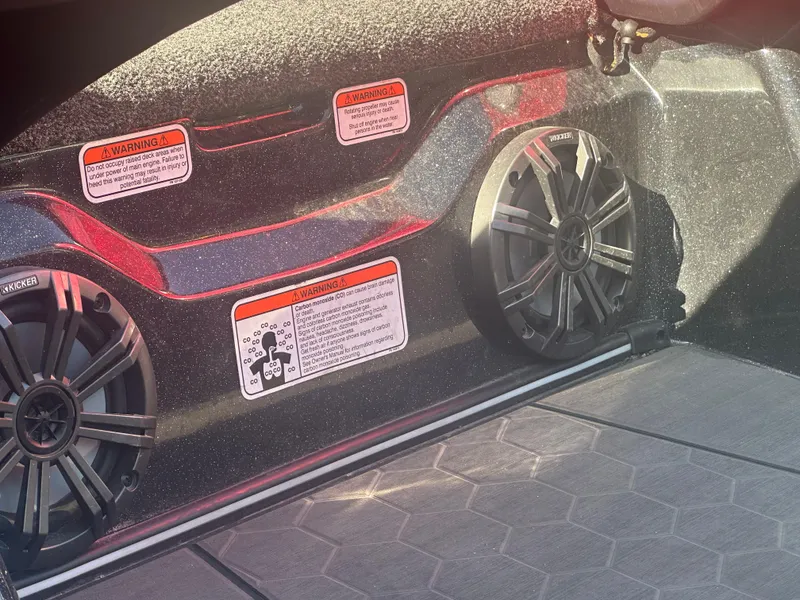 Slide: The Image of 2024 Nitro Z21XL boat interior with speakers and safety warning labels. - 16
