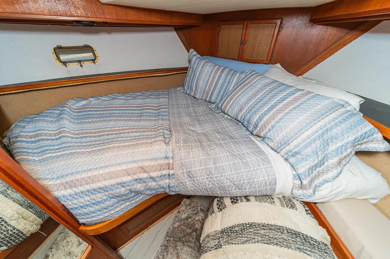 Slide: The Image of Cozy cabin bedroom in 1982 Viking 44 Motor Yacht with striped bedding. - 17