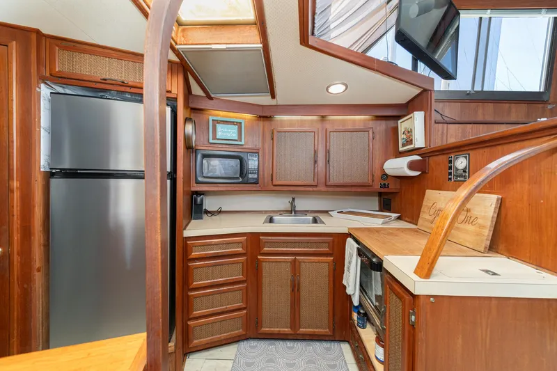 Slide: The Image of 1982 Viking 44 Motor Yacht kitchen with wood cabinetry, stainless steel appliances, and countertop. - 20