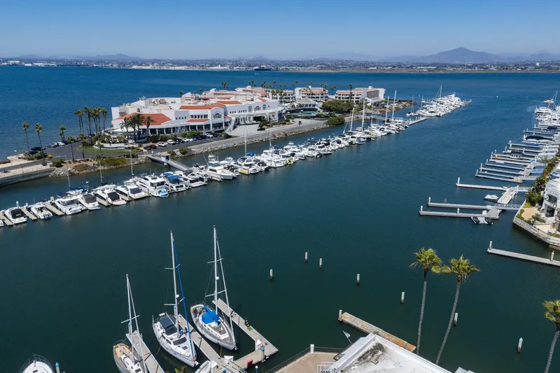 Slide: The Image of Aerial view of marina with yachts, including a 1982 Viking 44 Motor Yacht, under clear blue skies. - 24