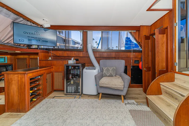 Slide: The Image of Interior of 1982 Viking 44 Motor Yacht with wooden cabinetry and cozy seating area. - 25