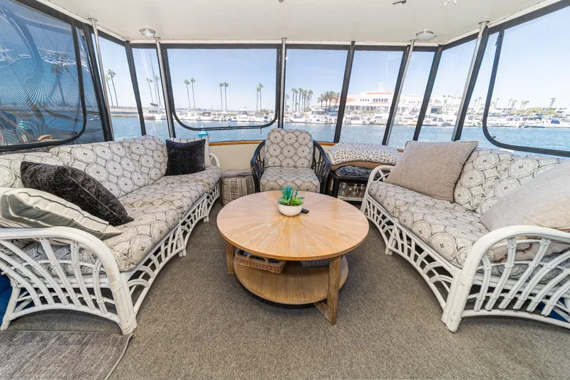Slide: The Image of Cozy interior of 1982 Viking 44 Motor Yacht with wicker seating and ocean view. - 32
