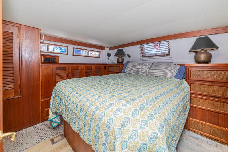 Slide: The Image of Cozy bedroom in 1982 Viking 44 Motor Yacht with wood paneling and patterned bedding. - 6