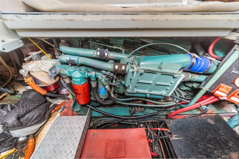 Slide: The Image of Engine compartment of a 1982 Viking 44 Motor Yacht, showcasing mechanical components and wiring. - 8