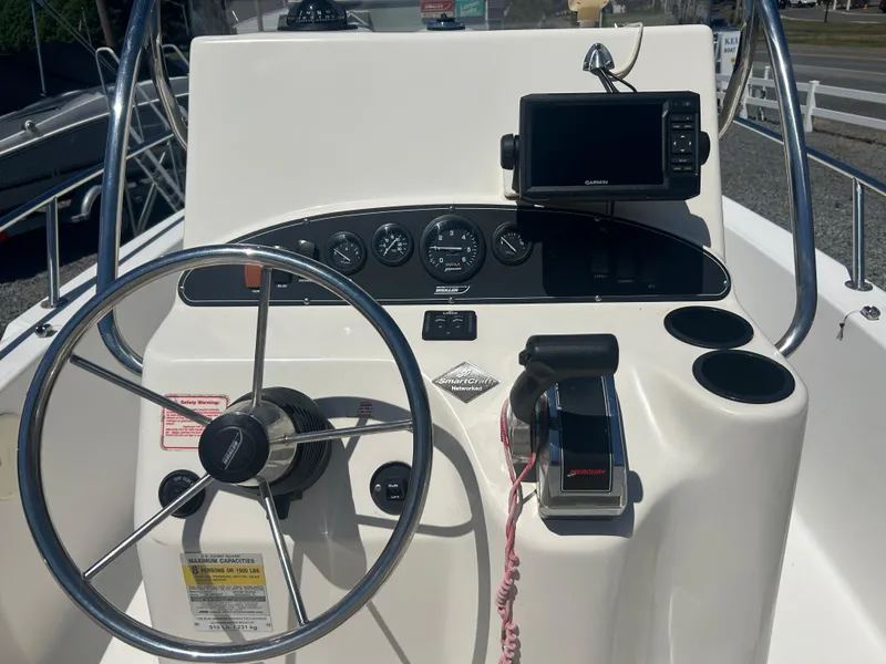 Slide: The Image of Boston Whaler 190 Nantucket 2004 boat dashboard with steering wheel and Garmin GPS. - 10