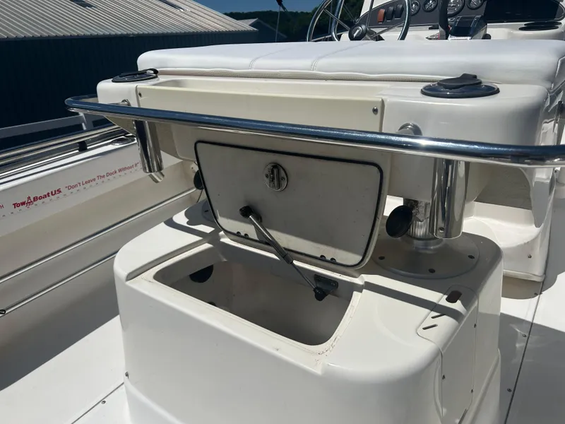 Slide: The Image of 2004 Boston Whaler 190 Nantucket boat console with storage compartment open. - 12