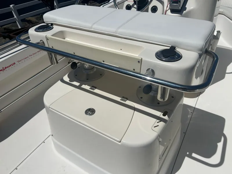 Slide: The Image of 2004 Boston Whaler 190 Nantucket boat interior with cushioned seating and storage. - 13