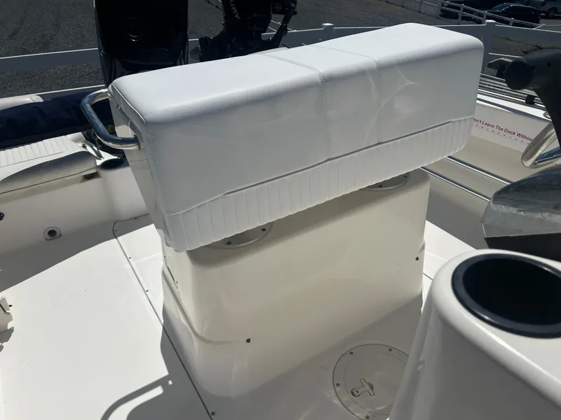 Slide: The Image of 2004 Boston Whaler 190 Nantucket boat interior with white seating and console. - 14