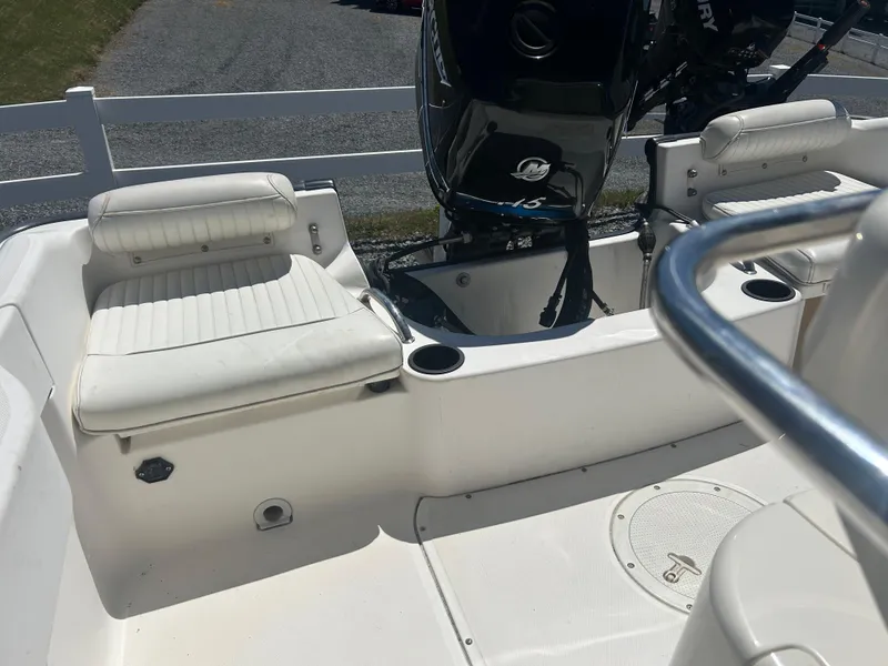 Slide: The Image of 2004 Boston Whaler 190 Nantucket boat interior with seating and Mercury outboard motor. - 17