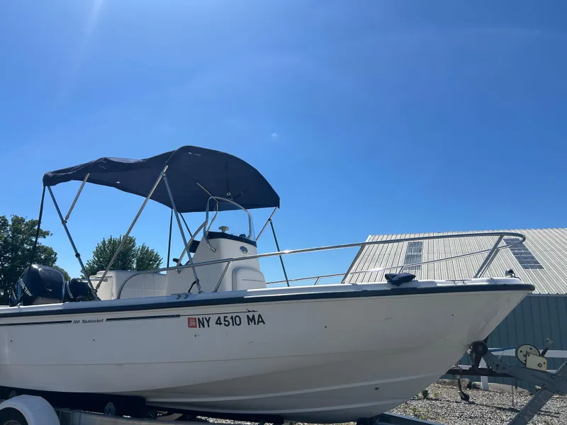 Slide: The Image of 2004 Boston Whaler 190 Nantucket boat on trailer under clear blue sky. - 2