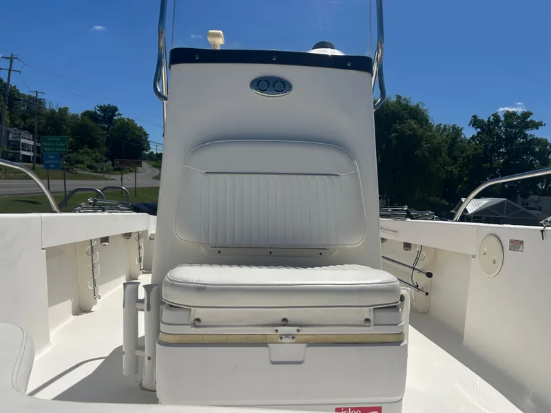 Slide: The Image of 2004 Boston Whaler 190 Nantucket boat interior with white seating and console. - 24