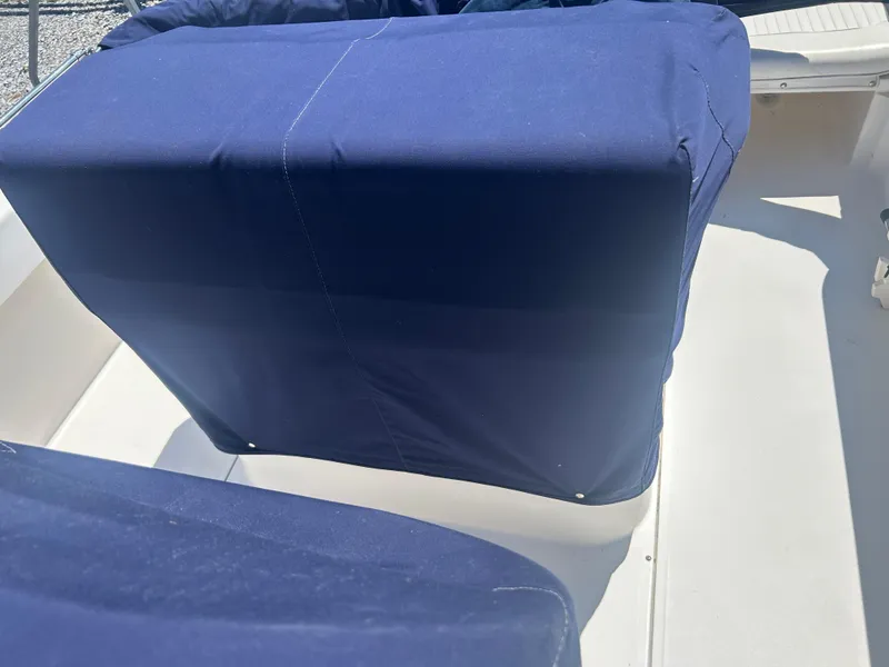 Slide: The Image of Blue-covered seating on a 2004 Boston Whaler 190 Nantucket boat. - 28