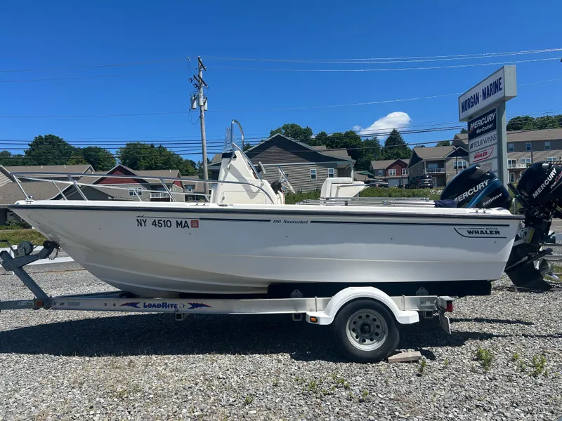 Slide: The Image of 2004 Boston Whaler 190 Nantucket boat on trailer, displayed outdoors at Morgan Marine. - 4