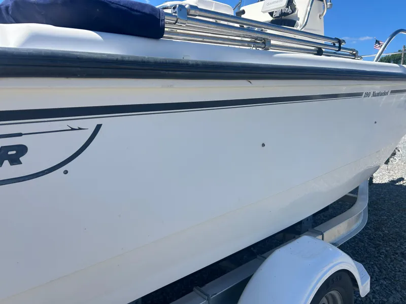 Slide: The Image of 2004 Boston Whaler 190 Nantucket boat on trailer, side view, clear sky background. - 7