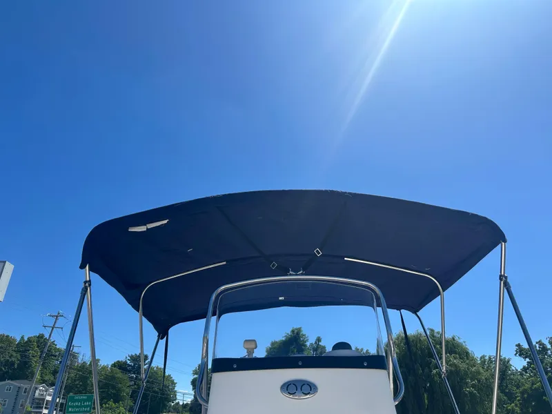 Slide: The Image of Boston Whaler 190 Nantucket boat with canopy under clear blue sky, 2004 model. - 8