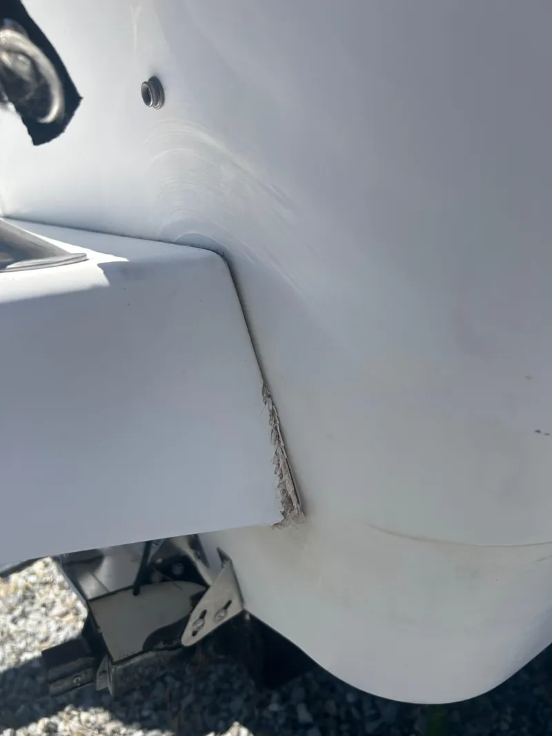 Slide: The Image of Close-up of 2004 Boston Whaler 190 Nantucket boat hull with visible damage. - 9